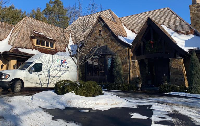 Ungerman service van parked at a residential home during a winter emergency response job