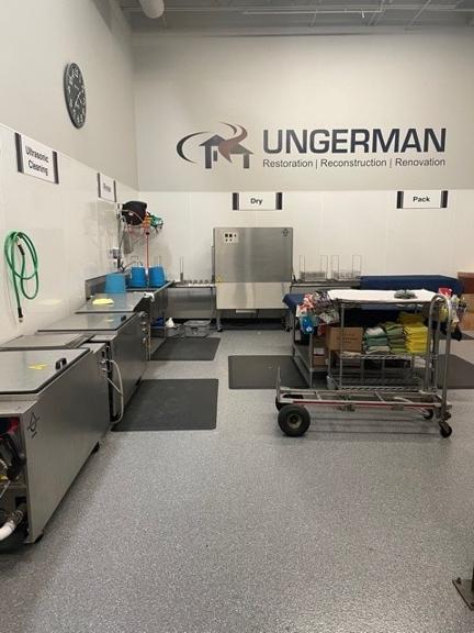 Ungerman's in-house contents cleanroom with ultrasonic cleaning, wash, dry, and pack stations for restoring personal property after a fire