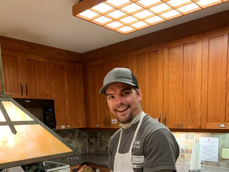 An Ungerman volunteer preparing a meal in the kitchen at Ronald McDonald House