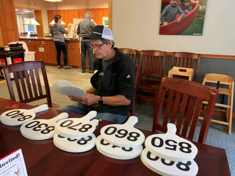 An Ungerman team member making numbered room signs for Ronald McDonald House
