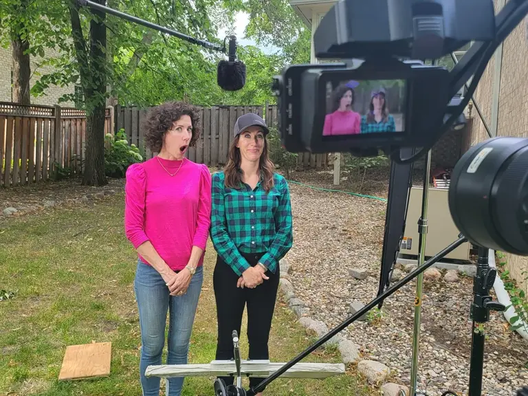 A camera rig and boom microphone set up to film two people in the backyard of a Twin Cities home during an HGTV Renovation 911 shoot