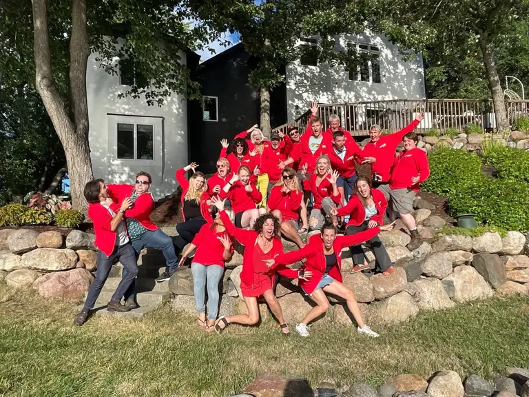 The Ungerman team gathered outdoors in matching red shirts for a group photo