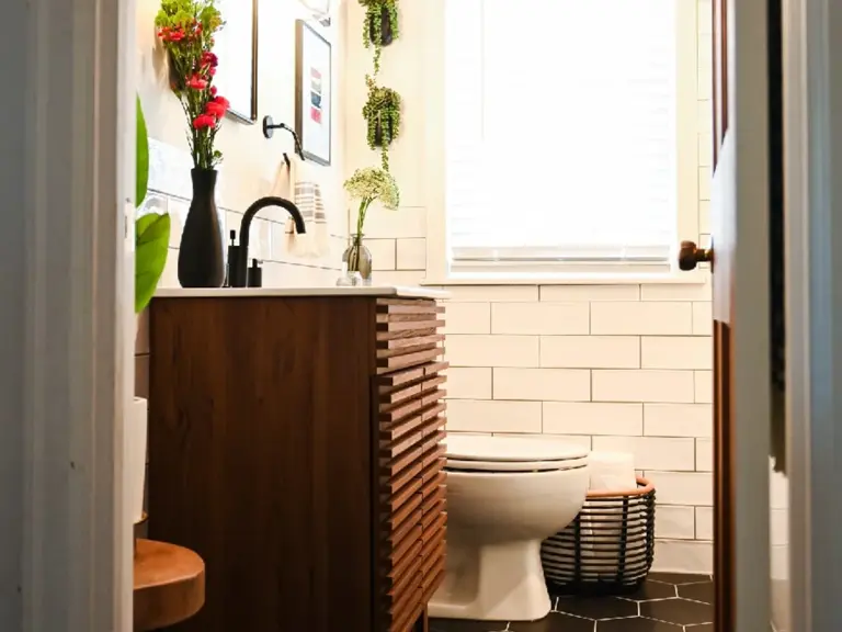 The same view rebuilt with a slatted walnut vanity, black fixtures, subway tile, and a black hexagon tile floor