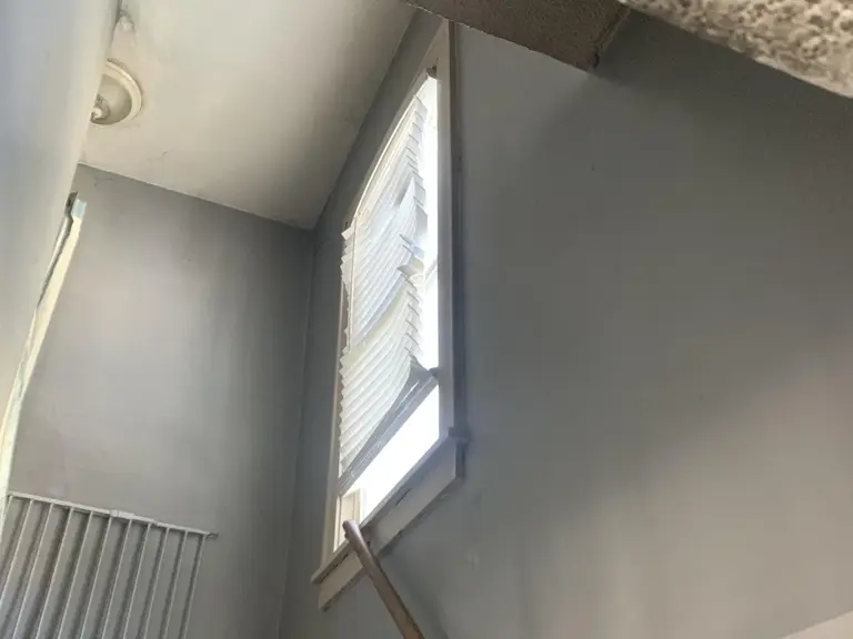 Stairwell stripped to bare walls during smoke and soot remediation after a house fire