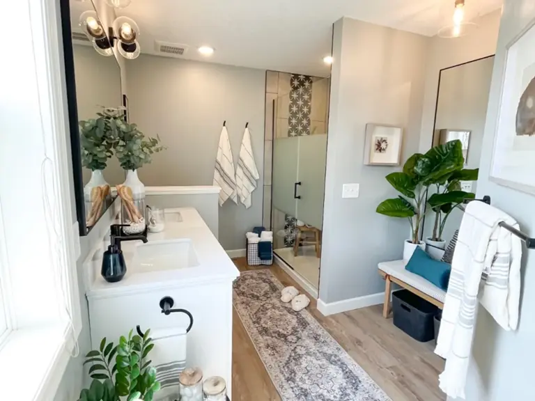 The same view rebuilt with a tiled walk-in glass shower and a dressing area where the sunken tub had been