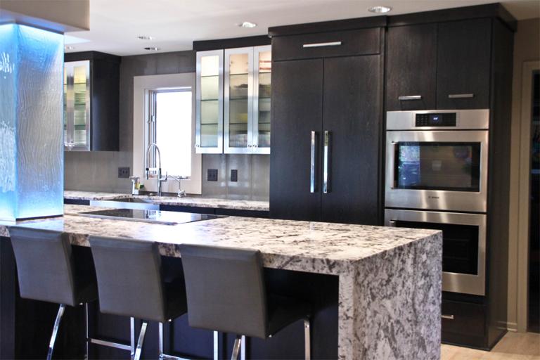 Modern kitchen with dark wood cabinetry, marble countertops, and stainless steel appliances. Four sleek barstools line the kitchen island.