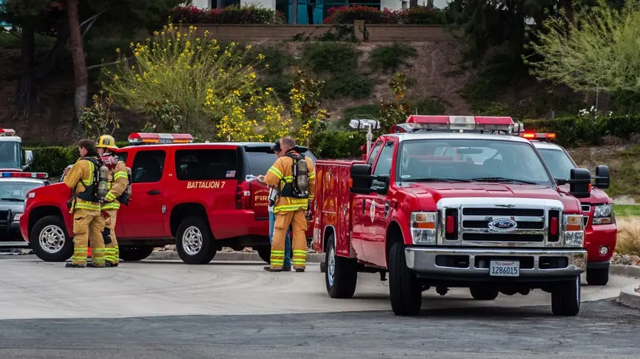 Fire trucks and firefighters responding at a commercial property