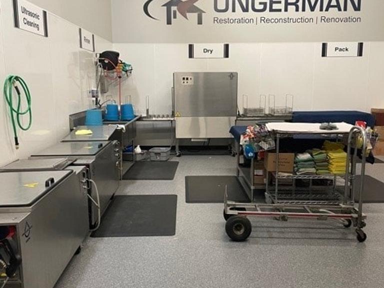 Ungerman's in-house contents cleanroom with ultrasonic cleaning, wash, dry, and pack stations for restoring personal property after a fire