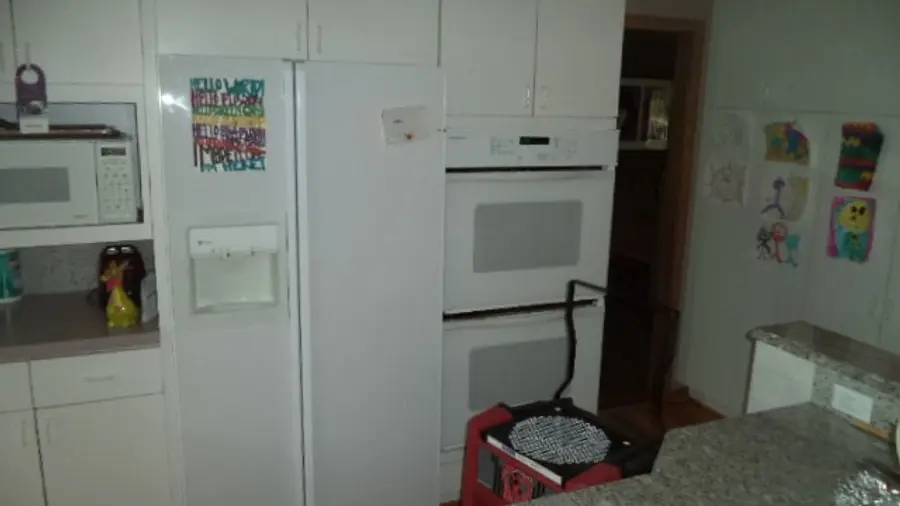 A dated kitchen with contents cleared out during water damage restoration