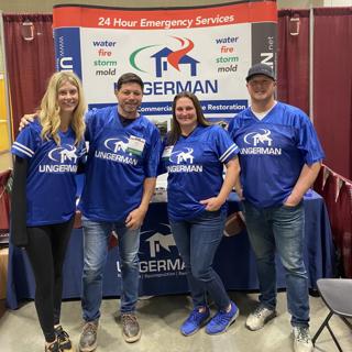 Ungerman team members in branded jerseys at a Minnesota Multi Housing Association trade show booth.