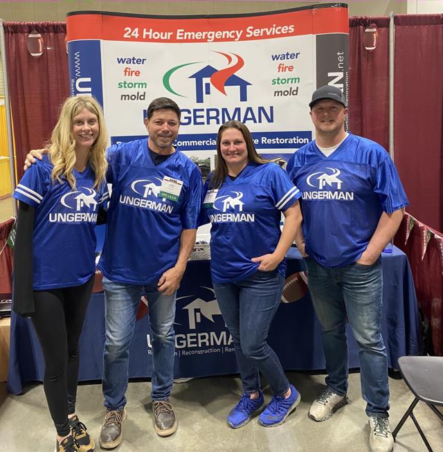 Ungerman team members in branded jerseys at an industry trade show booth.